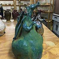 green clay dragon sculpture